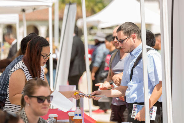 A student meeting with a representative at an information booth