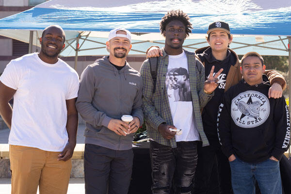 Group of male students of color standing together on campus